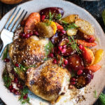 Spiced Chicken Thighs with garlicky tahini yogurt & pomegranate glazed carrots on a plate