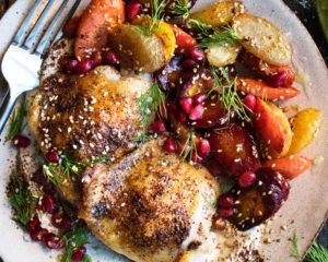 Spiced Chicken Thighs with garlicky tahini yogurt & pomegranate glazed carrots on a plate