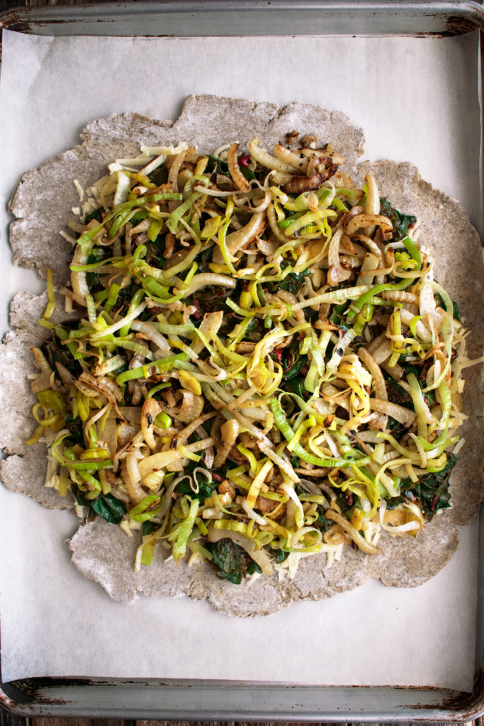 rolled out dough with fennel and leeks on top