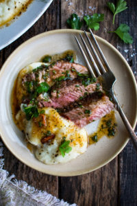 three slices of steak on a plate with a spoonful of whipped cauliflower