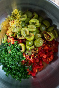red pepper and olive relish ingredients in a mixing bowl