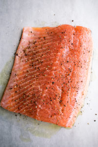 raw salmon filet on a piece of parchment