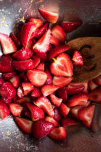 strawberries macerating in a mixing bowl