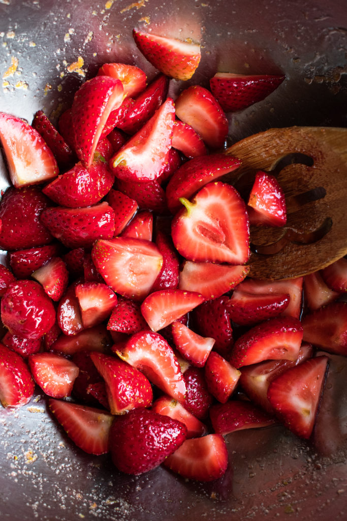 strawberries macerating in a mixing bowl