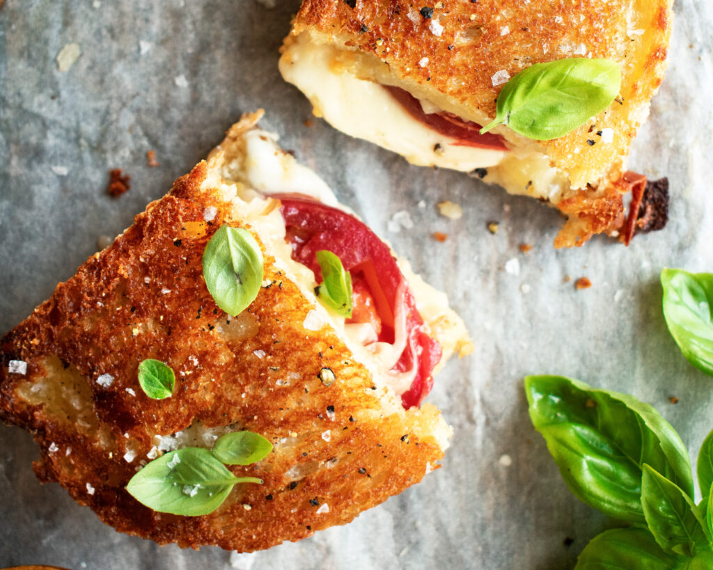 caprese grilled cheese sandwich cut in half