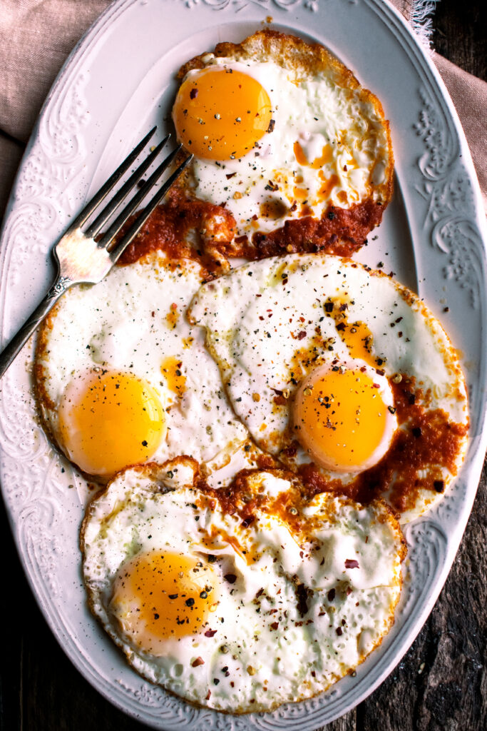 plate of four fried eggs