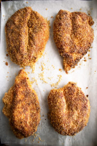 tortilla chip crusted chicken on a sheet pan out of the oven