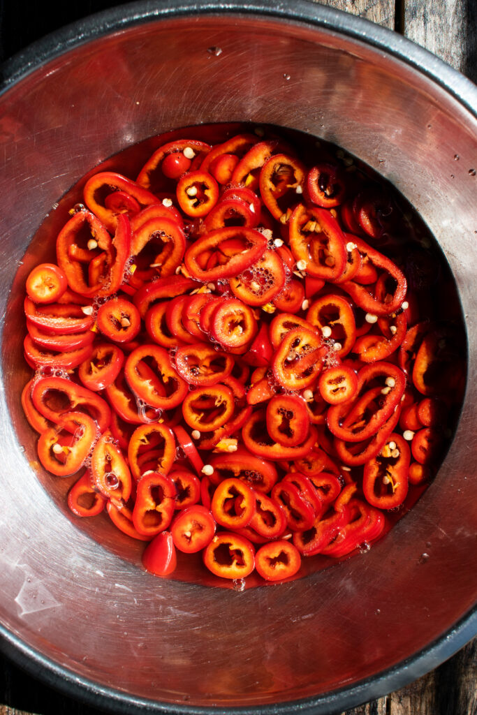 bowl of pickled red fresno peppers