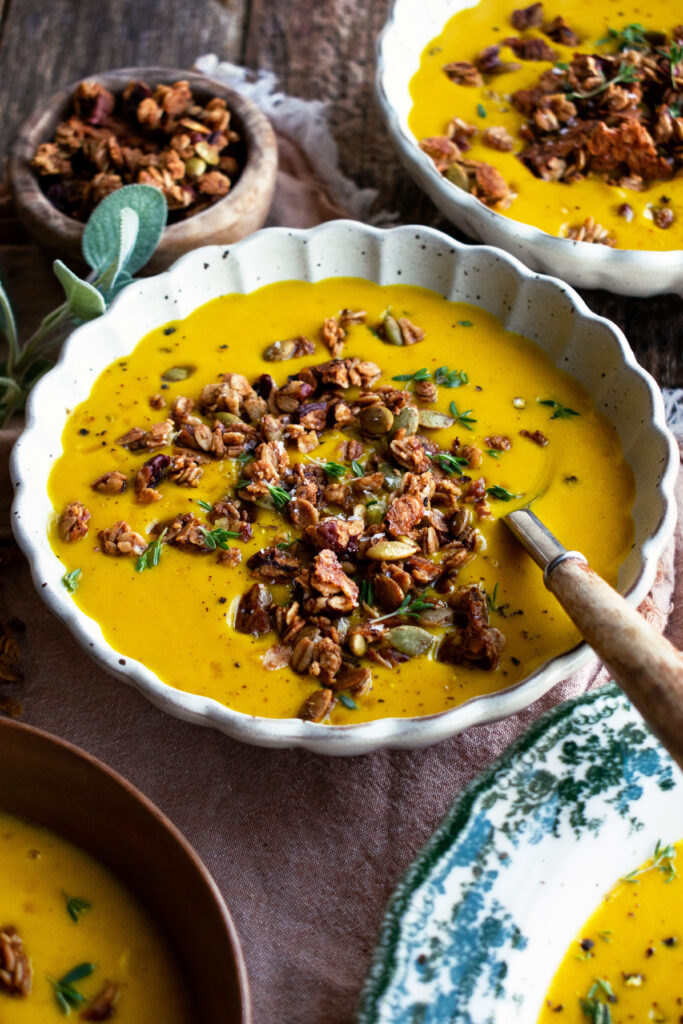 bowls of spiced butternut squash soup with granola on top