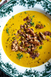 bowl of spiced butternut squash soup with granola on top