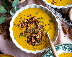 bowls of spiced butternut squash soup with granola on top