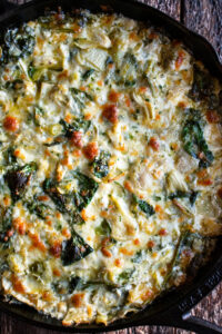 Cheesy Baked Spinach Artichoke Dip in a skillet