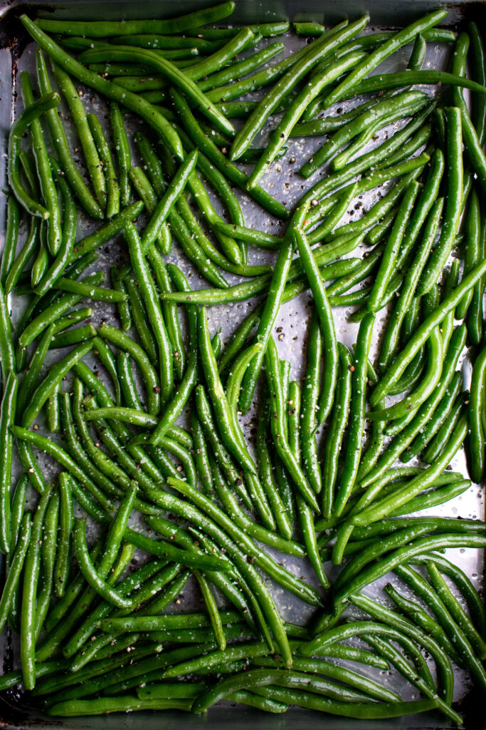 green beans on a sheet pan before roasting