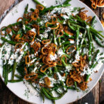Roasted Green Beans with buttermilk dressing and crispy shallots on a plate