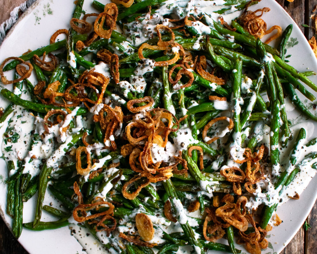 Roasted Green Beans with buttermilk dressing and crispy shallots on a plate