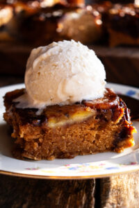 one square of bananas foster cinnamon cake with ice cream on top