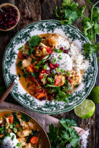 bowl of Thai chicken curry served over rice with toppings