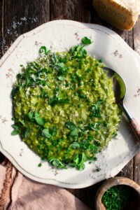 a plate of Spring Pea Risotto with herbs and parmesan over top