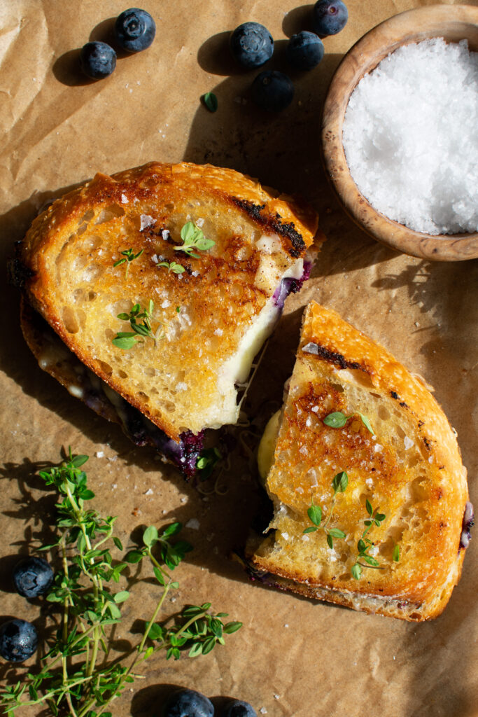 one Blueberry White Cheddar Grilled Cheese sandwich cut in half