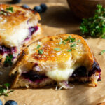 interior view of the Blueberry White Cheddar Grilled Cheese sandwich with melted cheese and jam