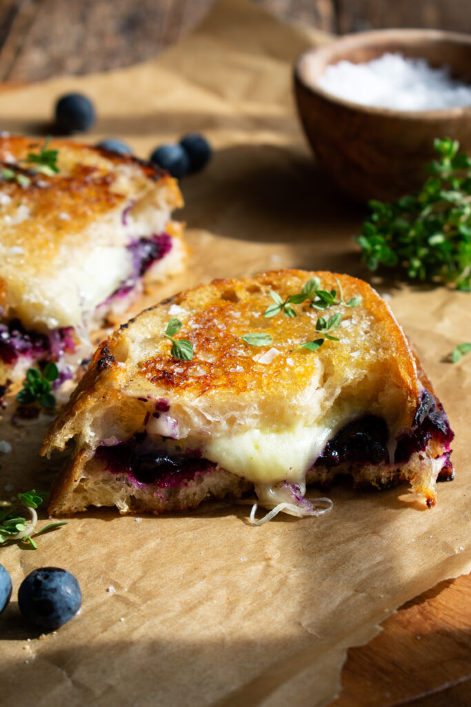 interior view of the Blueberry White Cheddar Grilled Cheese sandwich with melted cheese and jam