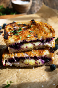 two halves of a Blueberry White Cheddar Grilled Cheese sandwich stacked