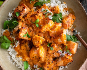 bowl of oven-roasted salmon & rice with creamy coconut tomato