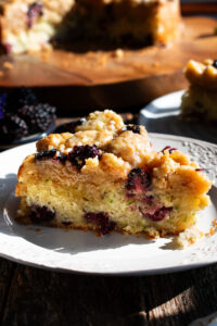 one slice of Blackberry Zucchini Coffee Cake on a plate