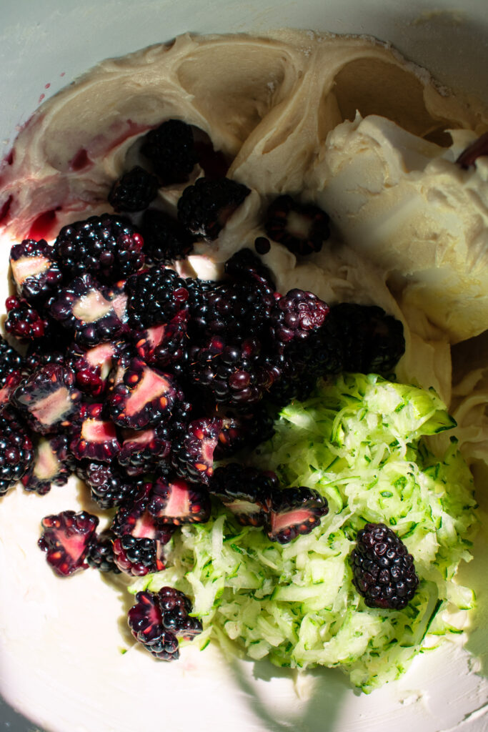 cake batter with blackberries and zucchini