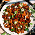 finished plate of roasted potatoes with goat cheese & red pepper sauce