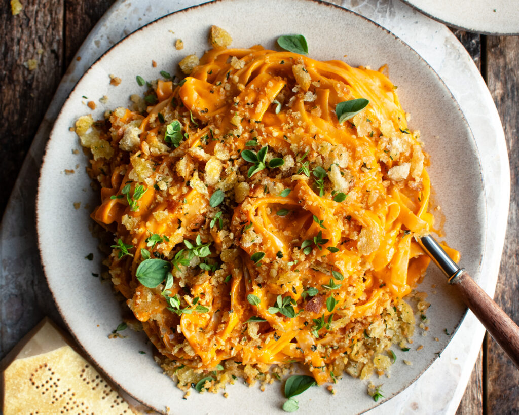 a plate of Creamy Tomato Pasta with herbed breadcrumbs on top