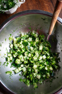 cucumber salad mixed in a bowl