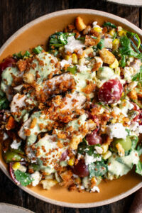 a plate of Grilled Chicken & Corn Salad with creamy dill dressing and breadcrumbs over top
