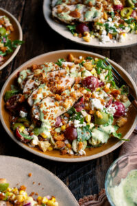 plates of Grilled Chicken & Corn Salad with creamy dill dressing and breadcrumbs over top