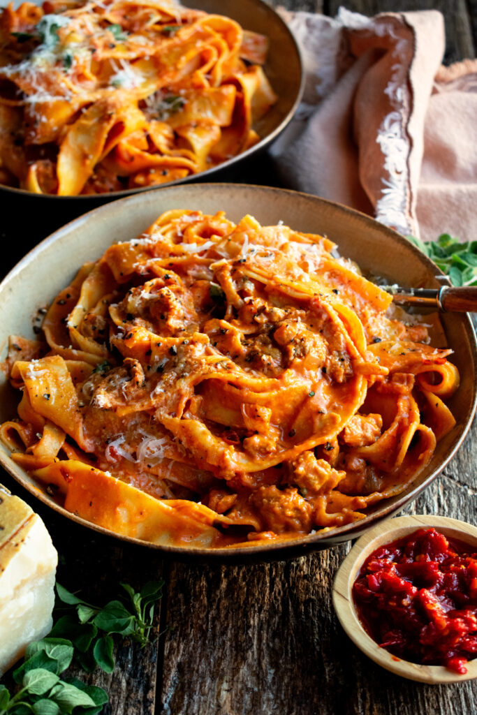 two bowls of Creamy Calabrian Chili Pappardelle with sausage & fennel