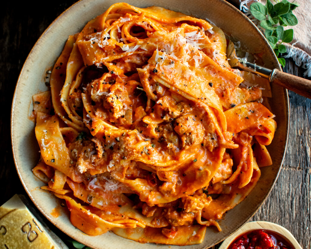 a bowl of Creamy Calabrian Chili Pappardelle with sausage & fennel
