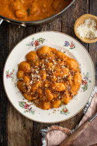 a plate of Gnocchi Alla Vodka with breadcrumbs and parmigiano over top