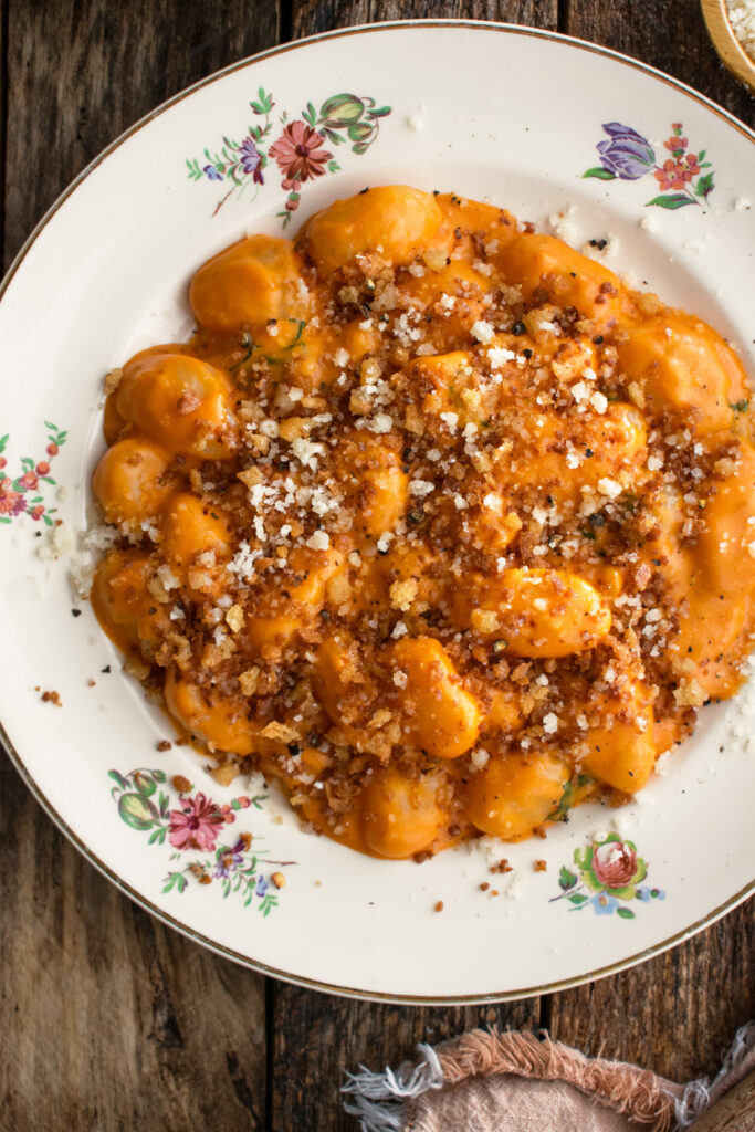 a plate of Gnocchi Alla Vodka with breadcrumbs and parmigiano over top