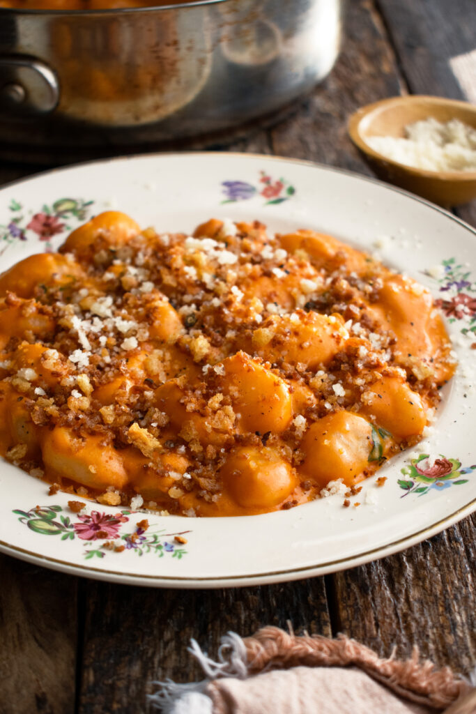 a plate of Gnocchi Alla Vodka with breadcrumbs and parmigiano over top