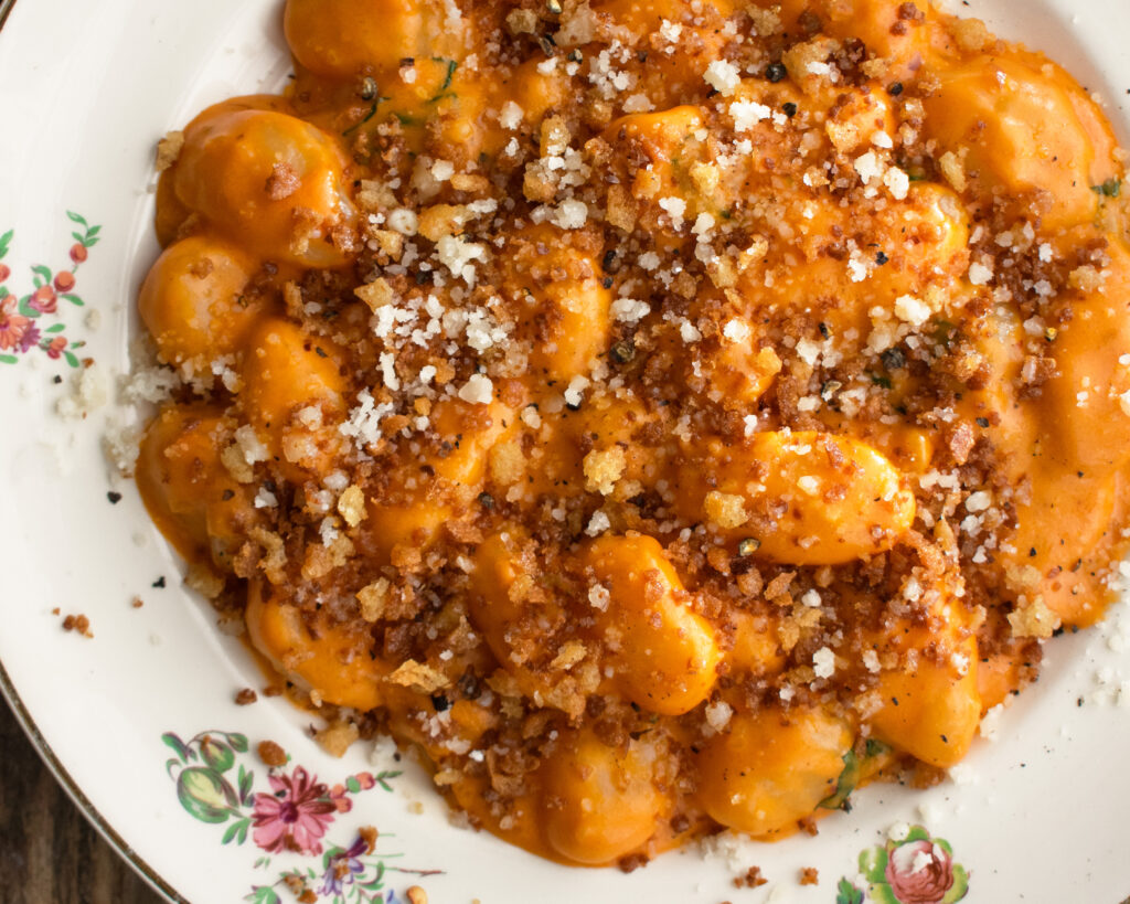 a plate of Gnocchi Alla Vodka with breadcrumbs and parmigiano over top