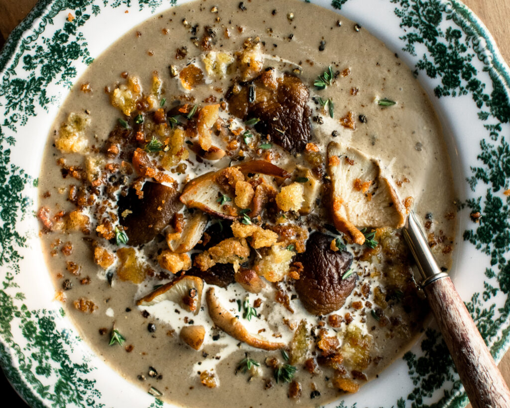 Creamy Mushroom Soup in a bowl with crispy rosemary breadcrumbs on top
