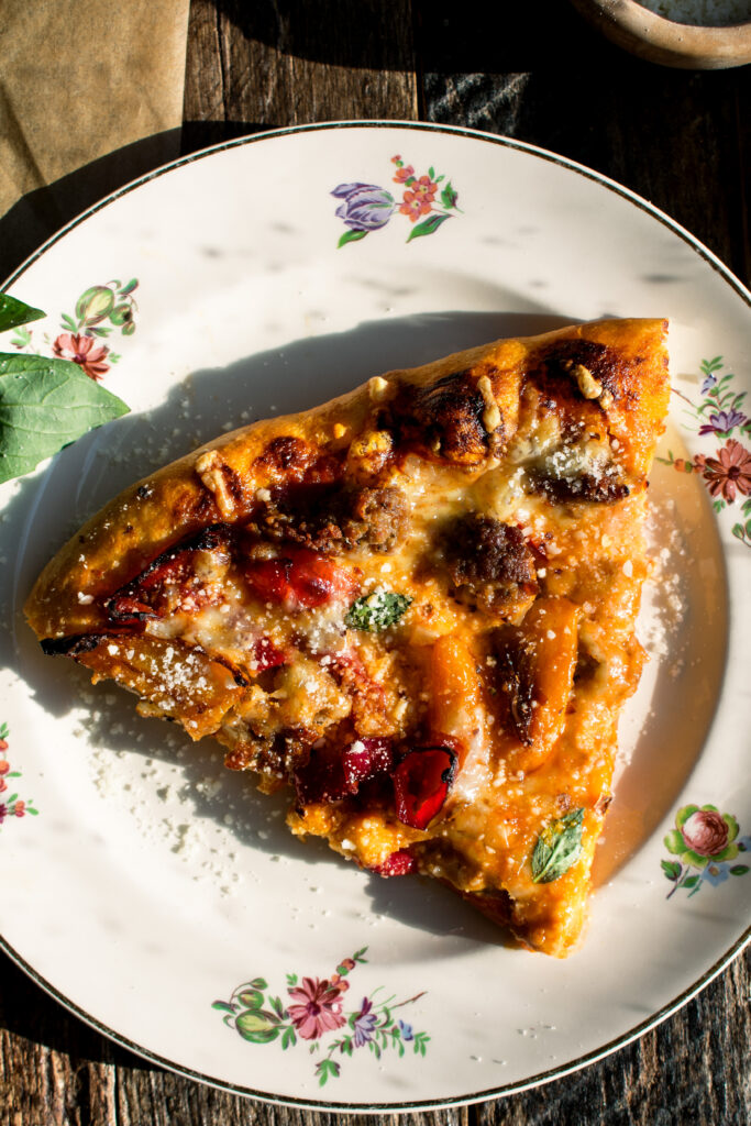 one slice of sausage & sweet pepper pizza