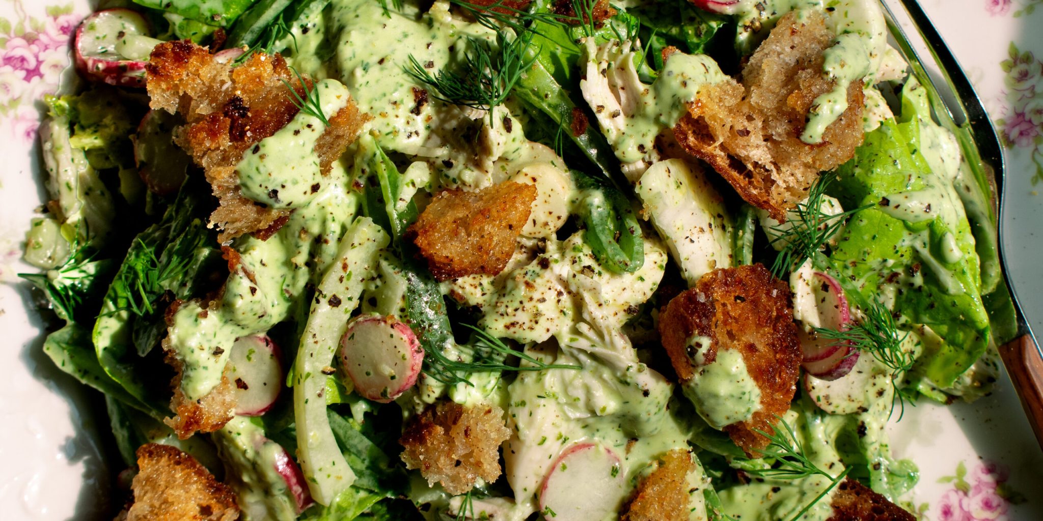 butter lettuce salad with chicken and herby yogurt dressing on a plate